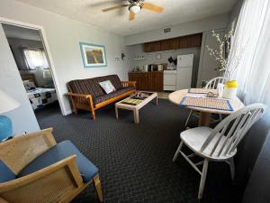 a living room with a couch and a table at Surfside Suites in Cocoa Beach