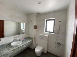 a bathroom with a sink and a toilet and a shower at Rubie Hotel in Ho Chi Minh City