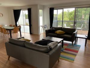 a living room with a couch and a table at Bay views on Laurie in Encounter Bay