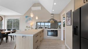 a kitchen with a counter and a dining room at Boat House in Metung