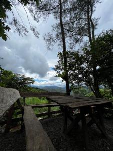 a picnic table with a view of the forest at Camp-Ula in Sampalok
