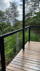 a wooden deck with a view of the ocean at Camp-Ula in Sampalok