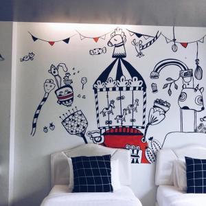 een slaapkamer met een muur met een tekening van een kooi bij Wannachart Boutique Resort in Tha Sala