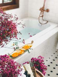 a bathroom with a bath tub with oranges on a tray at Villard123 in Ban Ton Phung +37 photos