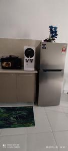 a kitchen with a refrigerator and a microwave at AYMAR Homestay, Residensi Lily, Nilai in Nilai
