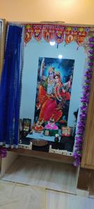 a table with a picture of two women on it at Brijlok Dham homestay in Mathura