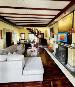 a living room with a couch and a fireplace at Balinese Villa in Berastagi in Berastagi