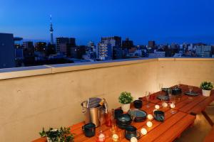 a table on a rooftop with a view of a city at Kiyosumi SOHO in Tokyo