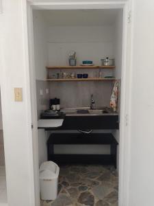 a kitchen with a sink and a trash can at Acogedor Apartaestudio Santa Fe in Medellín