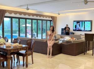 a woman in a dress standing in a living room at Anka Villa Venuestay in Vĩnh Phúc