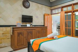 Posteľ alebo postele v izbe v ubytovaní Homestay Simply Homy Jogja dekat Gembira Loka Zoo