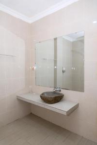 a bathroom with a sink and a large mirror at Green Prundi Hotel in Labuan Bajo