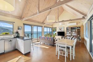 a kitchen and dining room with a view of the ocean at Altair in Wye River
