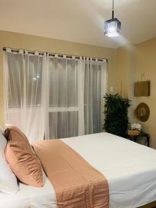 a bedroom with a large bed and a window at Richjones Bed & Breakfast in Manila +11 photos