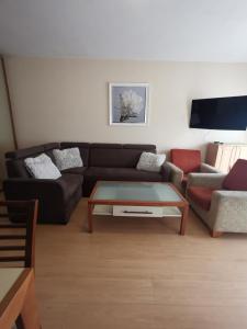 a living room with a couch and a coffee table at Apartament Reymonta przy morzu in Kołobrzeg