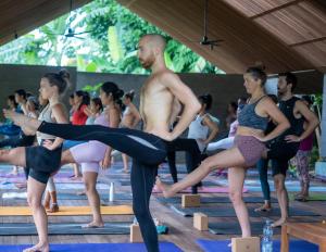 a group of people in a yoga class at Ubuntu Bali Eco Yoga Retreat - CANGGU in Canggu