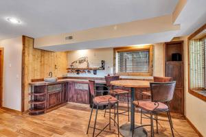 a kitchen with a table and chairs in a room at Charming 4 Bedroom 4 bathroom Lake view home in Lampe