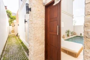 a door leading into a courtyard with a swimming pool at Green Twin - Cosy 2 BDR central Villa w/Pool. in Dalung