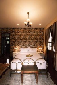 a bedroom with a bed and a chandelier at Villard123 in Ban Ton Phung