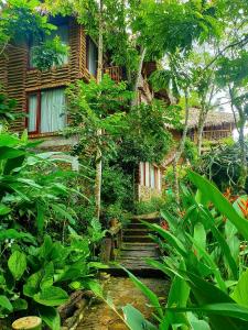 a stairway leading up to a building with trees at Pu Luong Jungle Lodge in Pu Luong