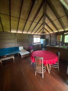 ein Esszimmer mit einem roten Tisch und Stühlen in der Unterkunft Chalet Mahina in Mahina