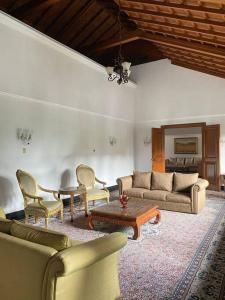 a living room with couches and a table and chairs at Rumah di Patra Kuningan, Jaksel in Jakarta