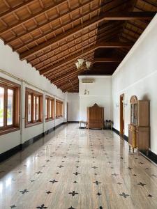 a large room with a large wooden floor and windows at Rumah di Patra Kuningan, Jaksel in Jakarta