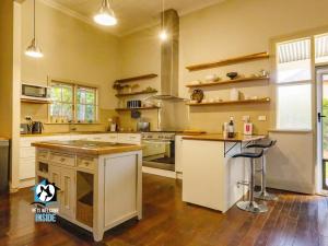 a large kitchen with a stove and a sink at The Graeme Addis Homestead in Kalgoorlie