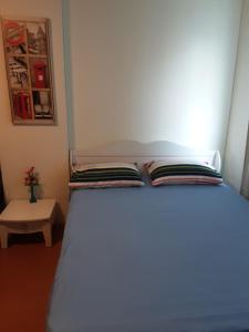 a bedroom with a bed with a book on it at IMPACT Challenger Apartment Hostel Bangkok Thailand in Pak Kret