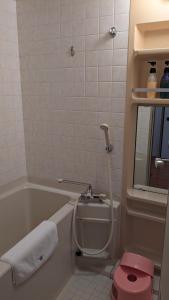 ein Badezimmer mit Toilette und Badewanne in der Unterkunft Miyajima Morinoyado in Miyajima