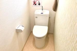 - une salle de bains avec des toilettes blanches dans une cabine dans l'établissement ゲストハウスわかばGuestHouse Wakaba in Iwami, à Iwamicho