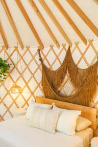 a bedroom with a hammock in a yurt at Camposanto Glamping - The Peacock Yurt in Austin