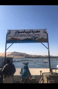 a sign with two people on a bike near the water at Nuba Heart in Aswan