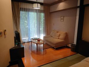 a living room with a couch and a table at Kasuga Hotel in Nara