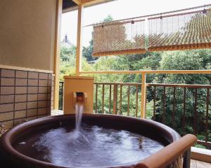 a water fountain in a large tub in a balcony at Kasuga Hotel in Nara