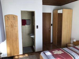 a bedroom with a bed and a bathroom with a sink at Gästehaus Wasserburger in Kernhof