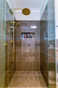 a shower with a glass door in a bathroom at Newly Built Guest House Walk to Lake in Toukley