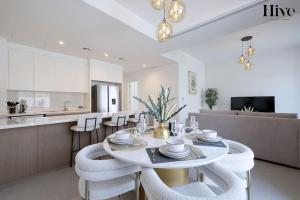 a kitchen and living room with a table and chairs at Ultra Modern 4 Bedroom Villa in Arabian Ranches 2 in Dubai
