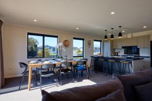 a kitchen and living room with a table and chairs at Pukeko Retreat in Kaikoura