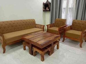 a living room with two couches and a coffee table at HareKrishna’s in Kharar
