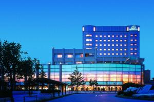 a large building with lights on in front of it at Hotel Port Plaza Chiba in Chiba