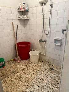 a bathroom with a bucket on the floor and a shower at Spacious House by the Sea in Gemlik
