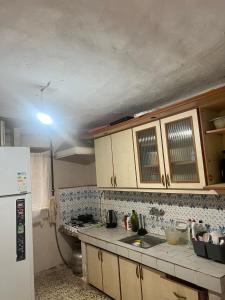 a kitchen with wooden cabinets and a white refrigerator at Spacious House by the Sea in Gemlik
