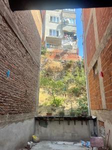 a view of a building from an alley between two buildings at Spacious House by the Sea in Gemlik