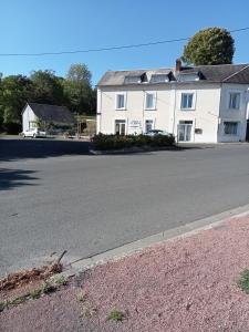 a large white house on the side of a street at Hôtel Restaurant de la Gare (Studios Du Breuil) in La Roche-Posay