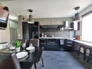 a kitchen with a table with wine glasses on it at Central Gem with Sauna - Big two-room apartment FREE PARKING in Tampere