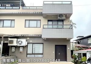 a large house with a balcony and a door at Yuanshan Dahu Homestay in Yuanshan