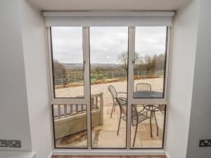 a view from a window of a balcony with a table and chairs at Cotswold View in Cheltenham