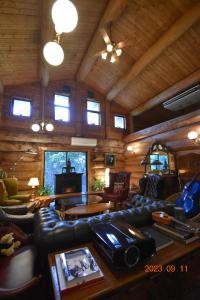 a living room with a couch and a table at Pension Prussian Blue in Miyako Island