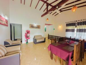 a dining room with a table and chairs at New Peacock Resort in Dambulla
